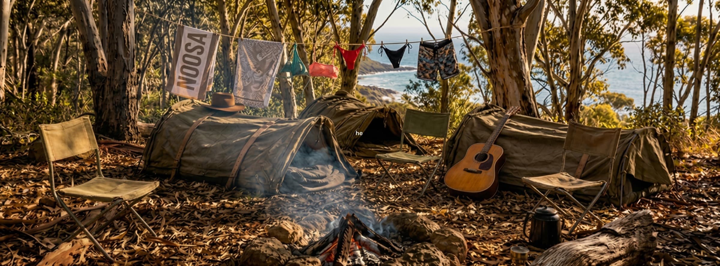 A campsite in the Australian bush — two canvas swags, a campfire, an acoustic guitar resting under cover, the ocean through the trees